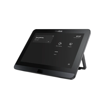 A touchscreen conference room control panel displaying meeting options and the current time, positioned on a stand.