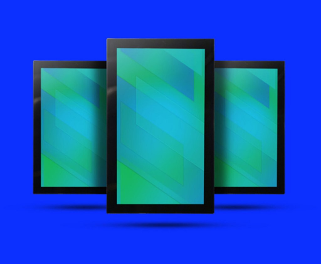 Three vertical black-framed monitors displaying green and blue geometric patterns are shown against a solid blue background.